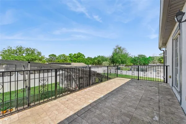 a balcony with trees in the background