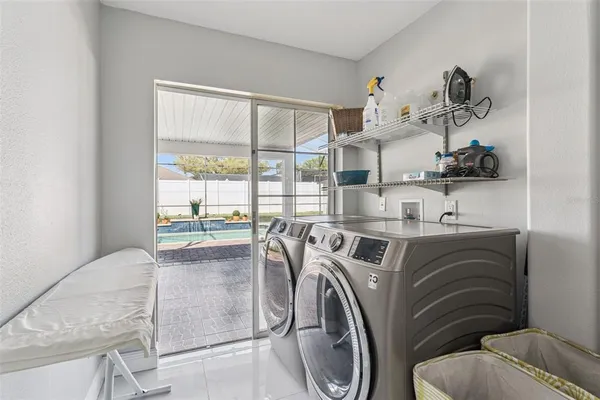 a utility room with sink dryer and washer