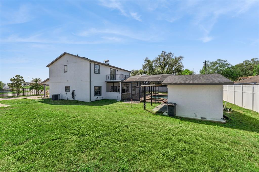 6053 New Hope Road Orlando, FL 32824 - Photo 33 of 40 a view of a house with backyard and garden