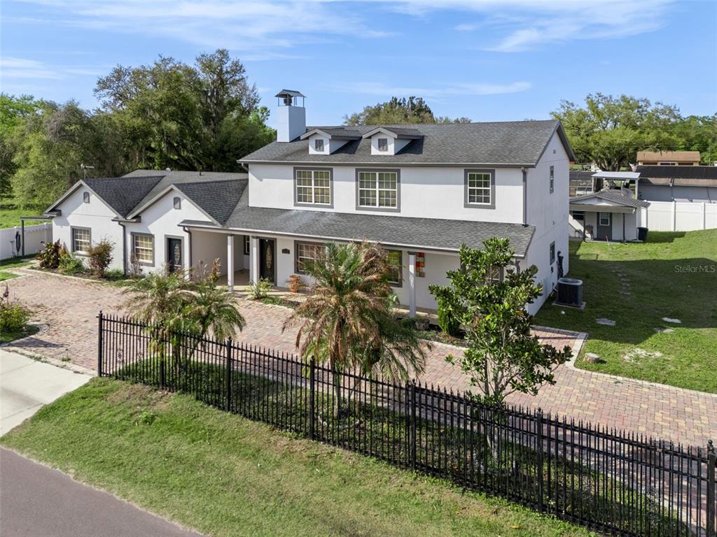 6053 New Hope Road Orlando, FL 32824 - Photo 34 of 40 a view of a house with a yard and potted plants
