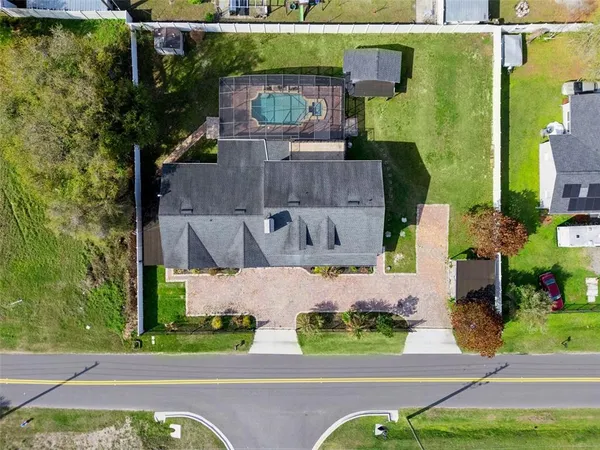 an aerial view of a house with a garden and yard