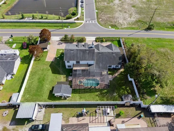an aerial view of a house with a garden and swimming pool