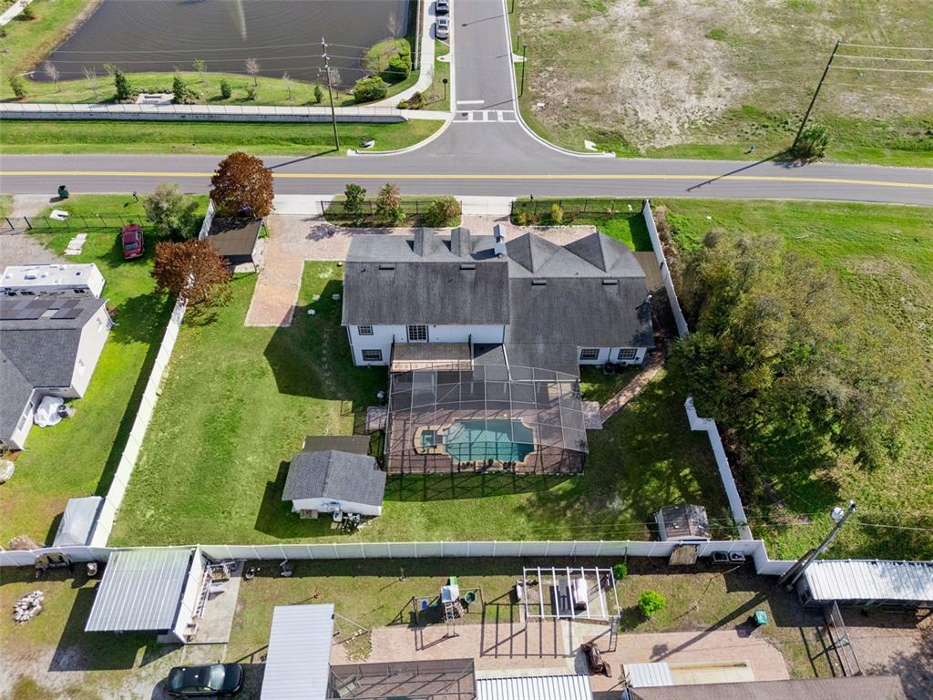 6053 New Hope Road Orlando, FL 32824 - Photo 38 of 40 an aerial view of a house with a garden and swimming pool