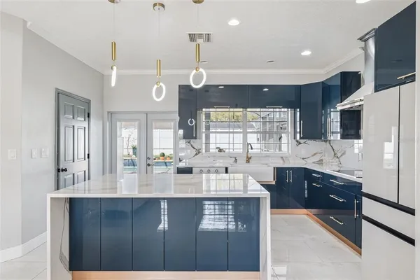 a large kitchen with granite countertop a sink window and refrigerator