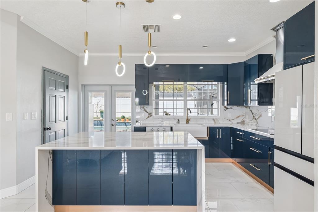 6053 New Hope Road Orlando, FL 32824 - Photo 10 of 40 a large kitchen with granite countertop a sink window and refrigerator
