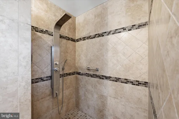 a bathroom with a window and a shower