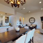 a very nice looking dining room with a table chairs and a chandelier