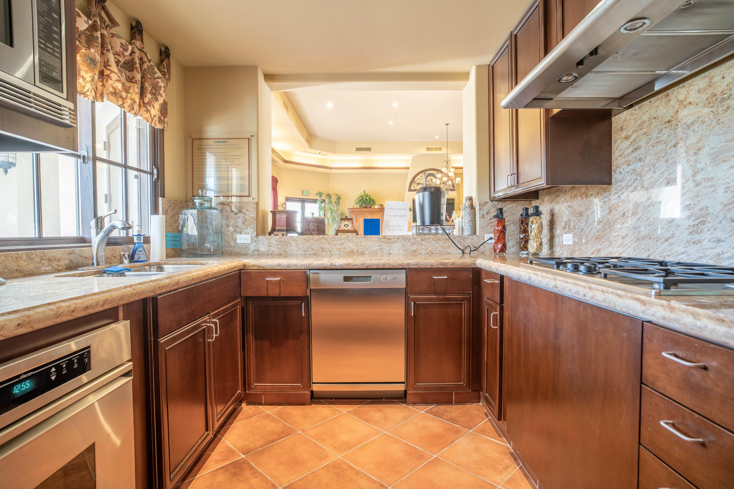 80777 Calle Azul La Quinta, CA 92253 - Photo 34 of 39 a kitchen with stainless steel appliances granite countertop a sink a stove and a refrigerator