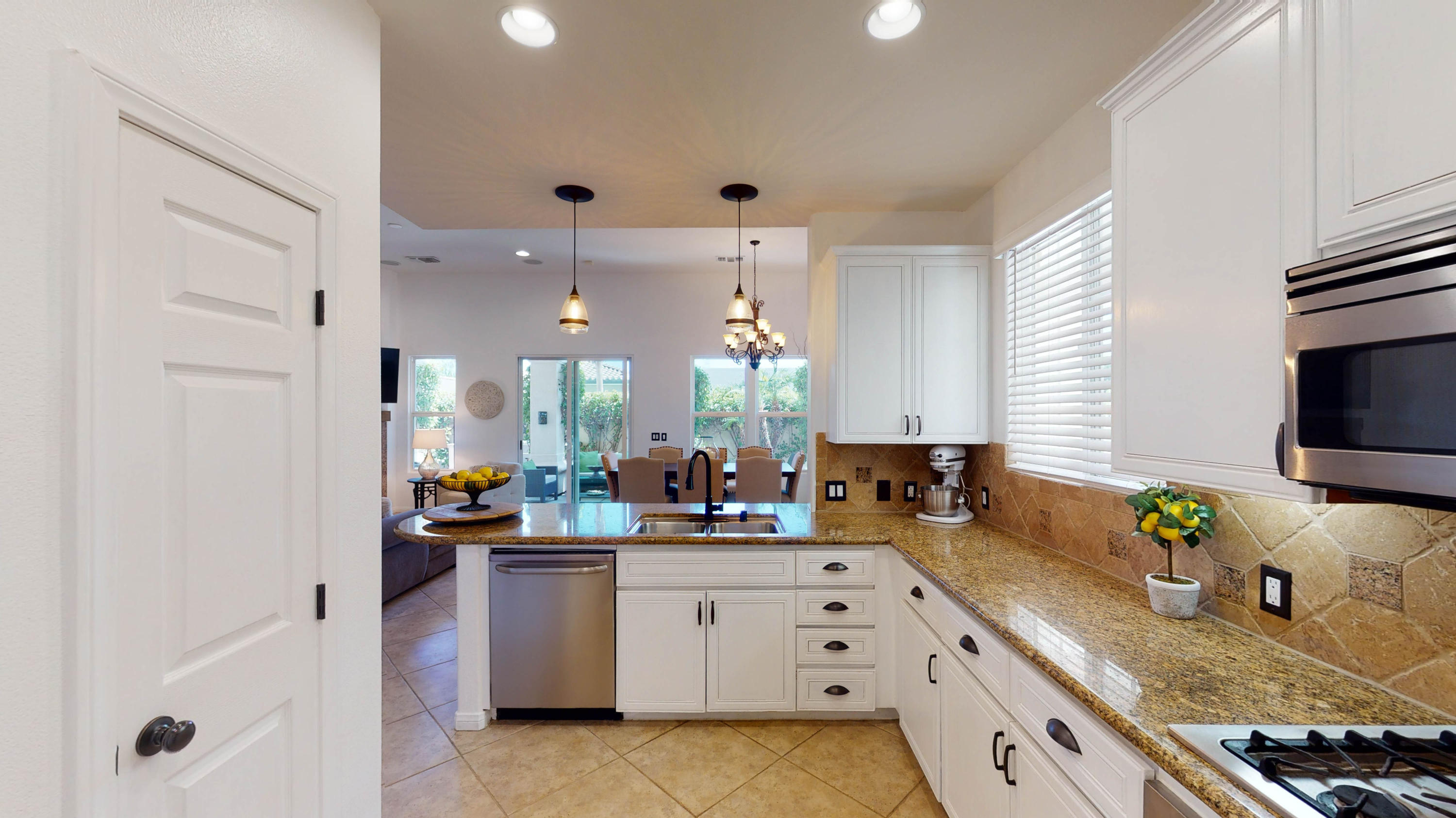 80777 Calle Azul La Quinta, CA 92253 - Photo 6 of 39 a kitchen with granite countertop a sink stove and cabinets