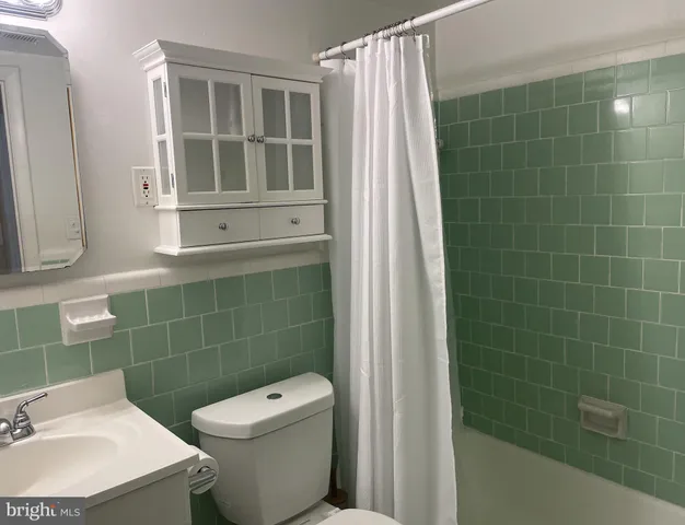 a bathroom with a toilet and a sink