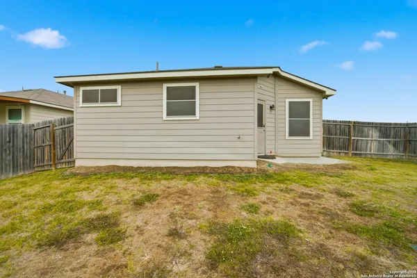 a view of a house with a backyard