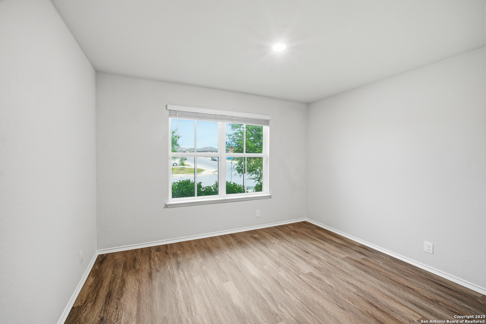 5803 Still River San Antonio, TX 78244 - Photo 10 of 15 an empty room with wooden floor and windows