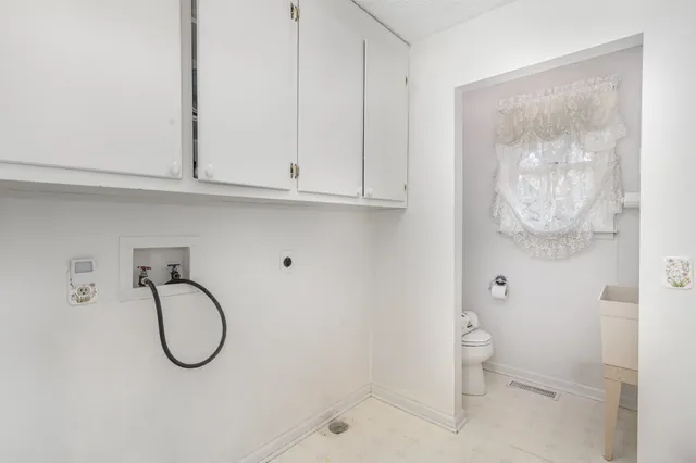 an empty room with windows and ceiling fan