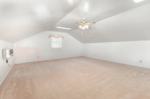 a view of a room with a ceiling fan