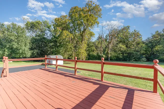 a view of backyard with barbeque grill and wooden fence