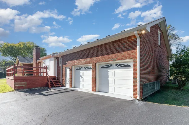 a front view of a house with yard and green space