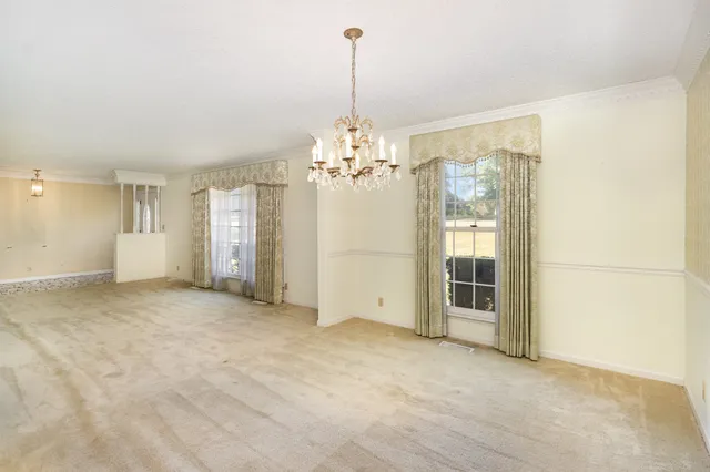 a view of a chandelier in big room and chandelier fan