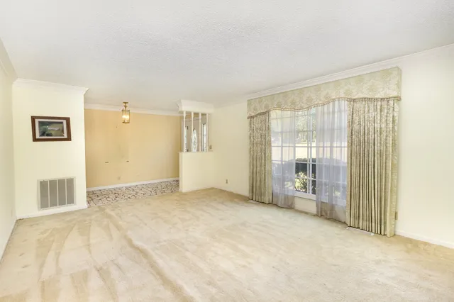 a view of an empty room with glass door