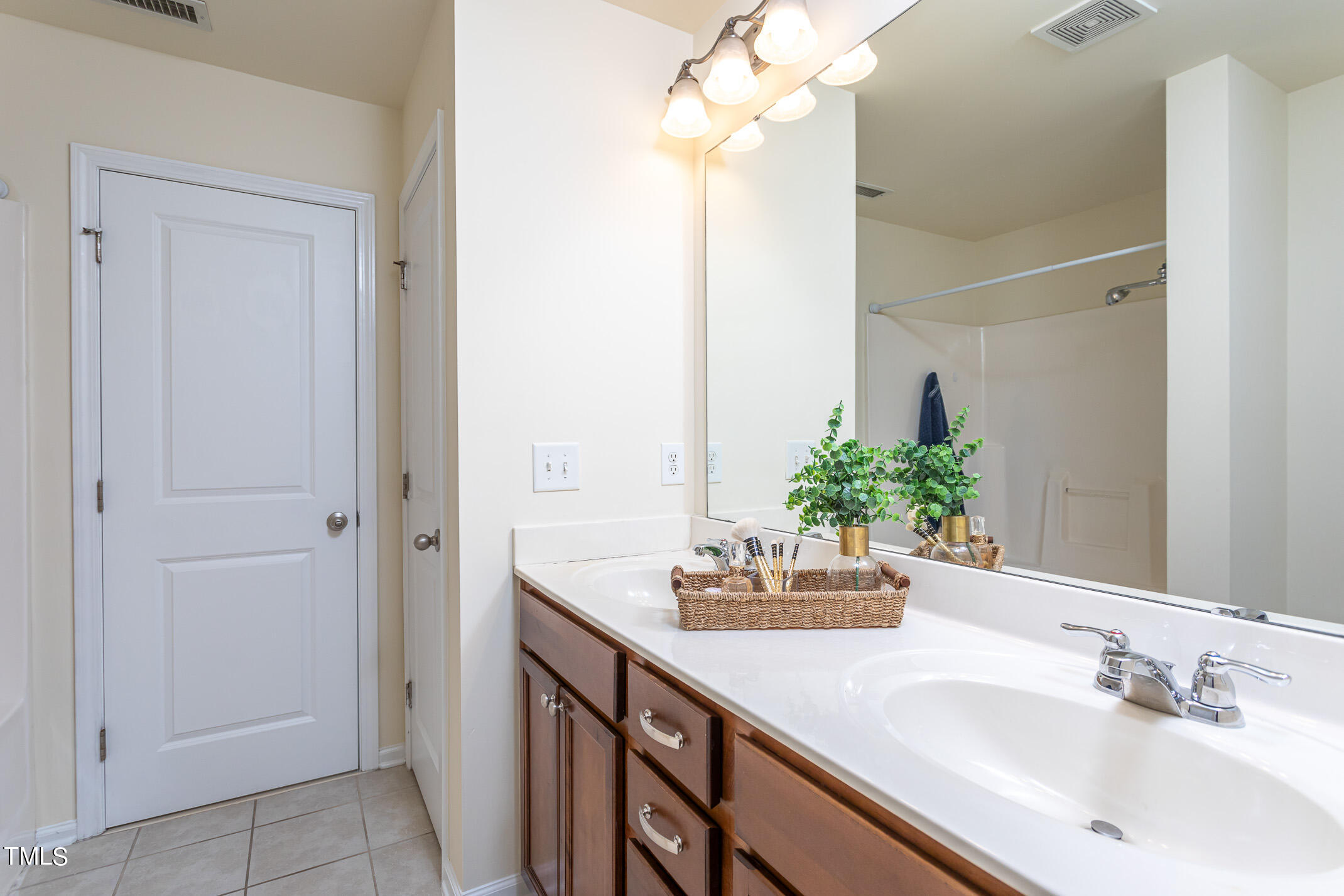 2302 Stoney Spring Drive Raleigh, NC 27610 - Photo 15 of 27 a bathroom with a sink vanity and a mirror