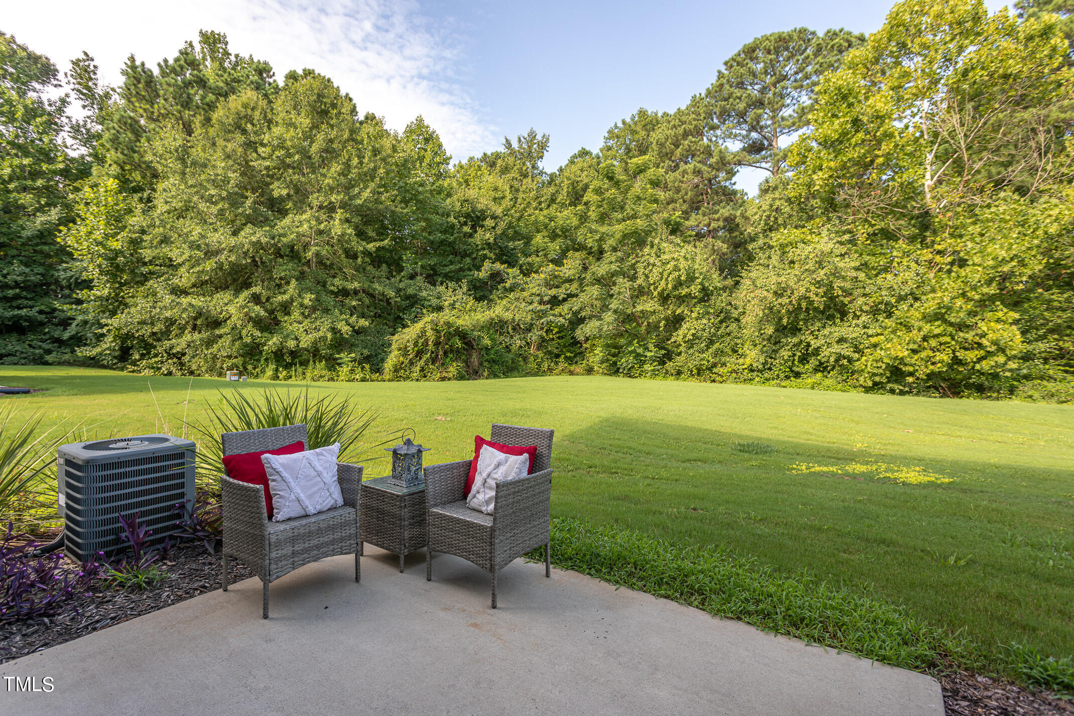 2302 Stoney Spring Drive Raleigh, NC 27610 - Photo 22 of 27 a view of a bench in the garden near a lake