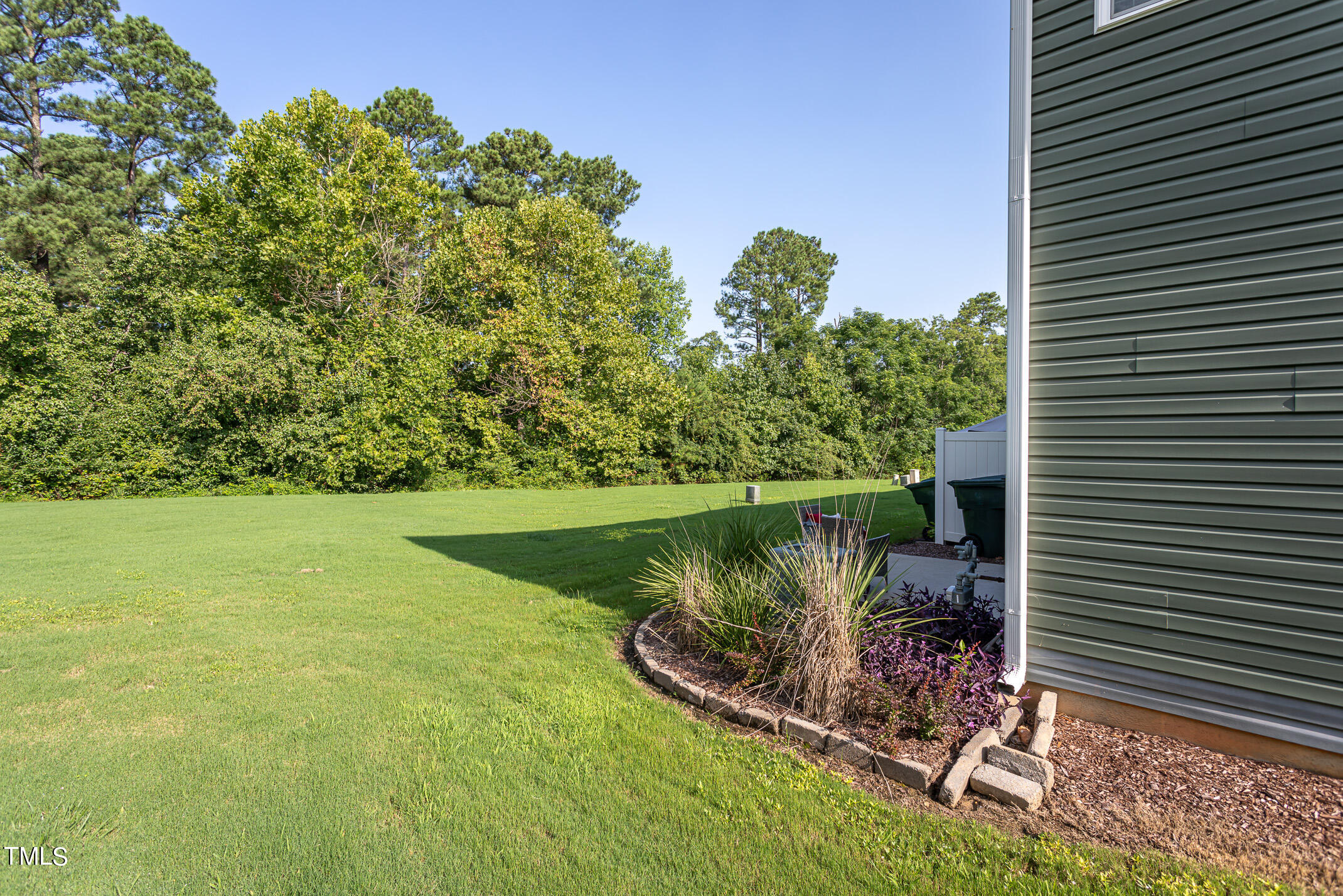 2302 Stoney Spring Drive Raleigh, NC 27610 - Photo 24 of 27 a view of a wooden deck with a yard