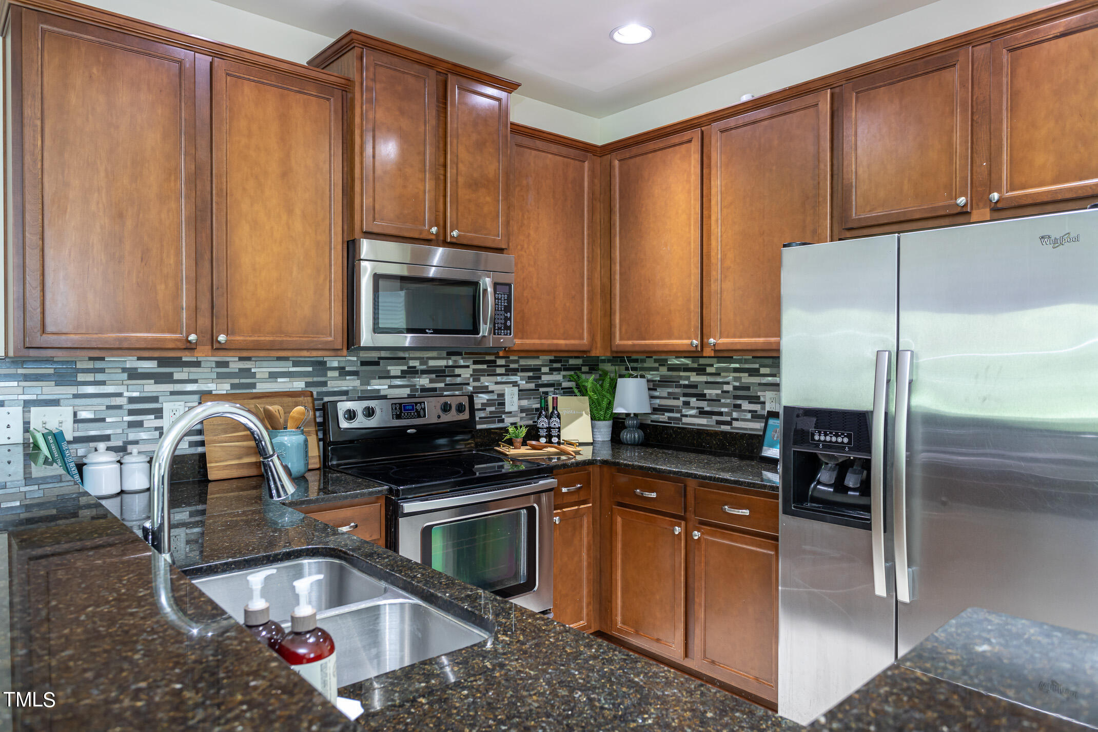 2302 Stoney Spring Drive Raleigh, NC 27610 - Photo 6 of 27 a kitchen with stainless steel appliances granite countertop a sink stove and refrigerator