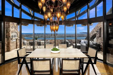 a dining room with furniture a chandelier and wooden floor