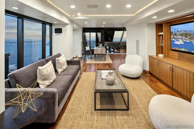 a view of a balcony with chairs and a floor to ceiling window