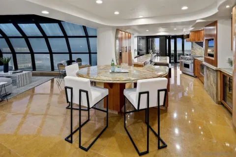 a bathroom with a granite countertop toilet sink and mirror