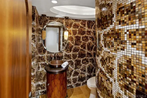 a view of a patio with table and chairs potted plants and palm trees