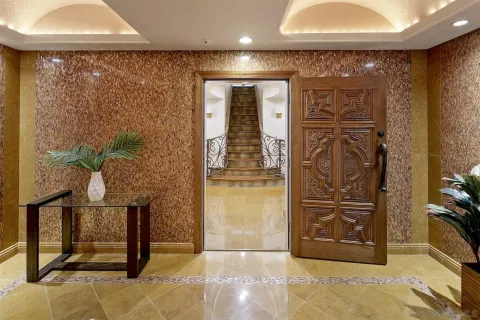 a living room with furniture a fireplace and a floor to ceiling window