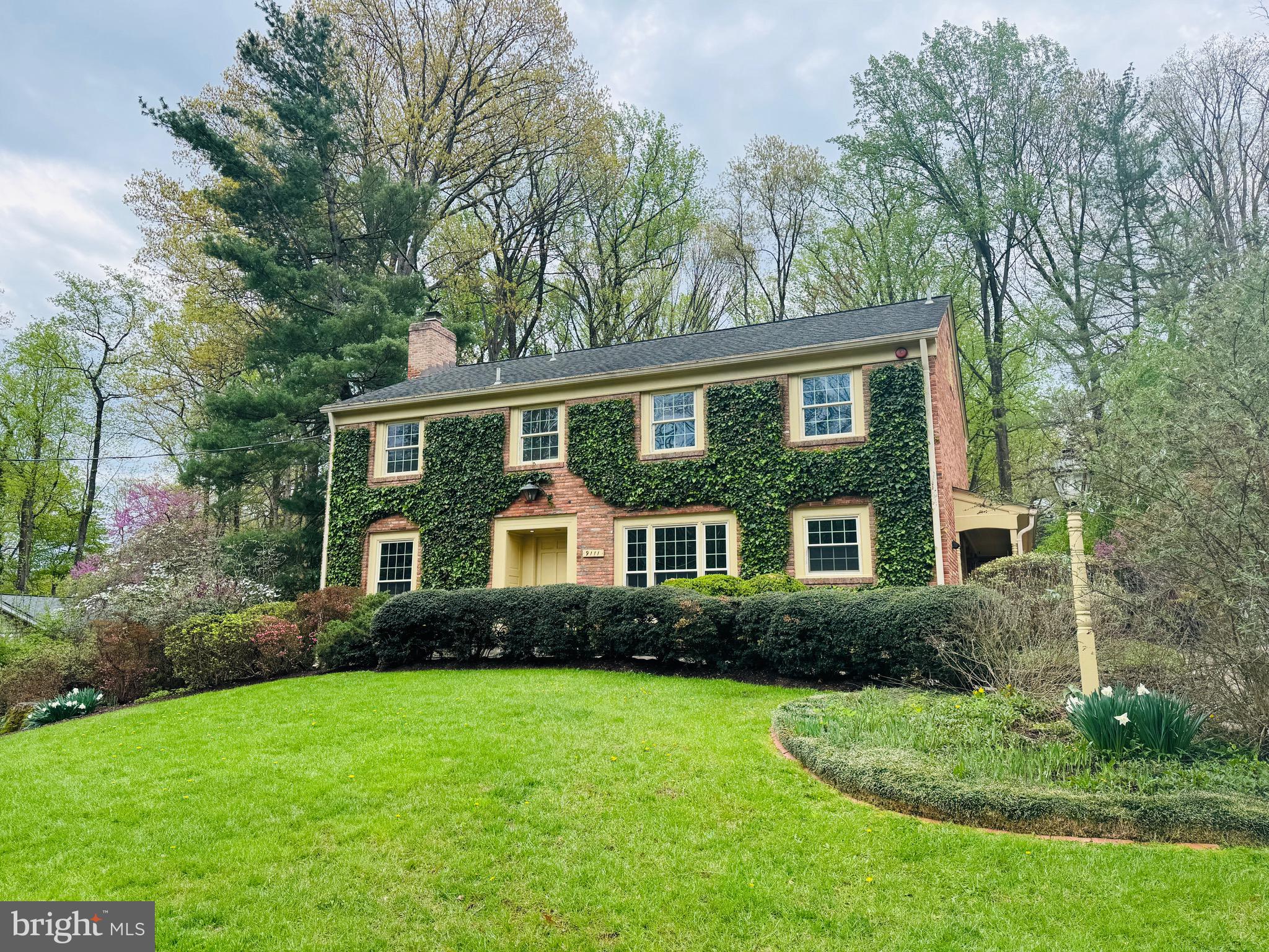 9111 Hamilton Drive Fairfax, VA 22031 - Photo 2 of 63 a front view of a house with a yard and trees