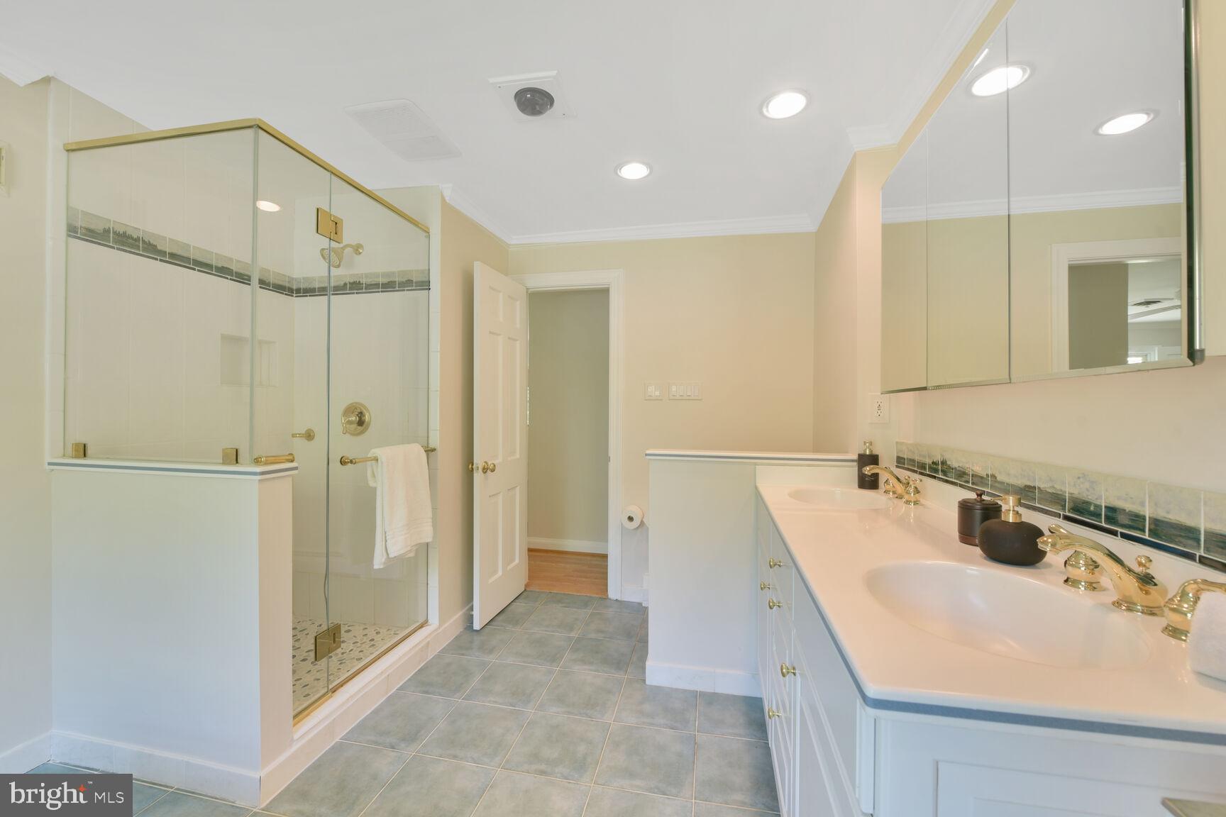 9111 Hamilton Drive Fairfax, VA 22031 - Photo 30 of 63 a bathroom with a sink a shower and a mirror