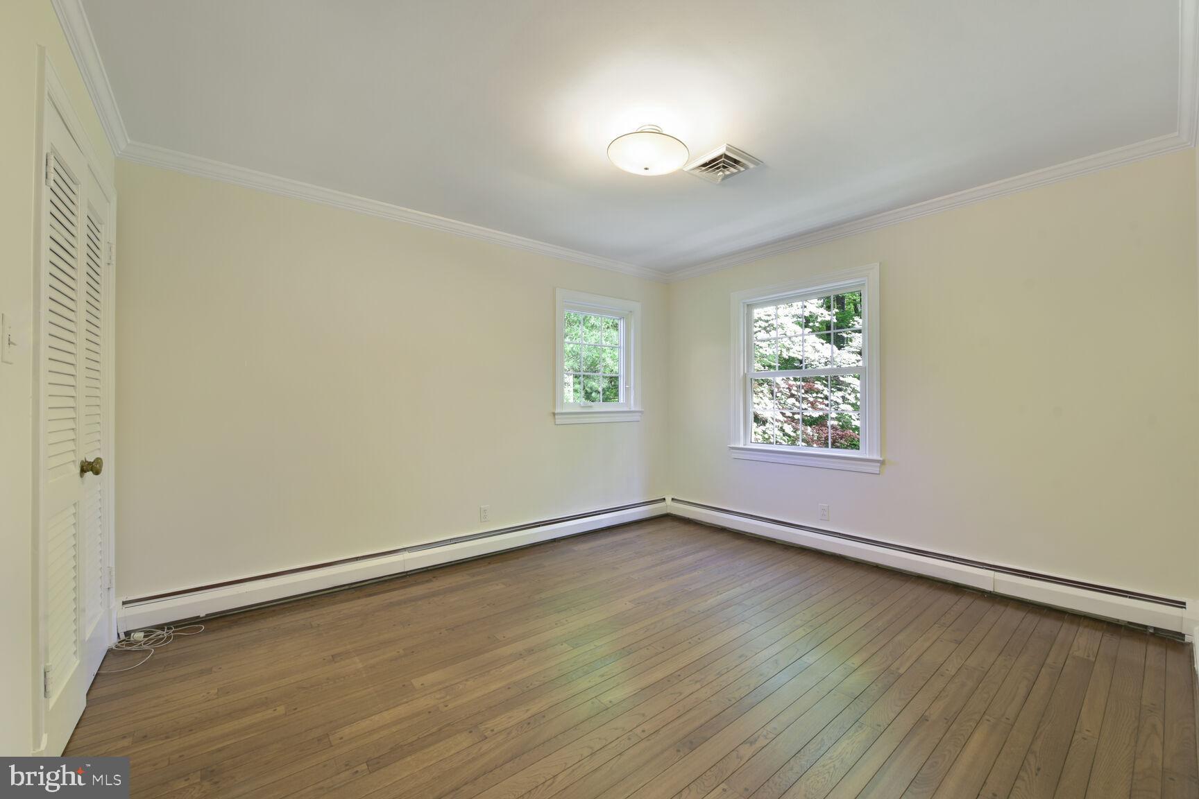 9111 Hamilton Drive Fairfax, VA 22031 - Photo 34 of 63 an empty room with wooden floor and windows