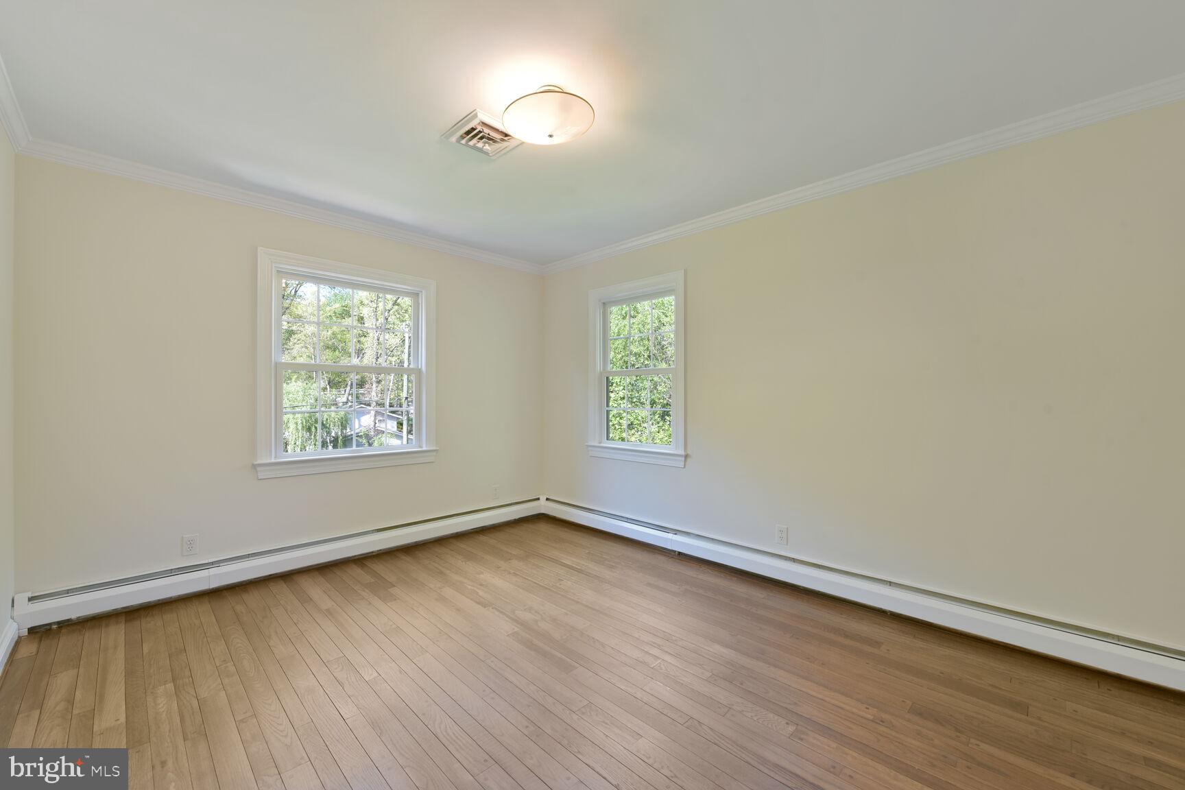 9111 Hamilton Drive Fairfax, VA 22031 - Photo 35 of 63 a view of an empty room with wooden floor and a window