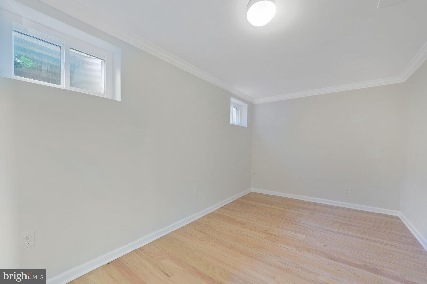9111 Hamilton Drive Fairfax, VA 22031 - Photo 43 of 63 a view of an empty room with wooden floor and a window
