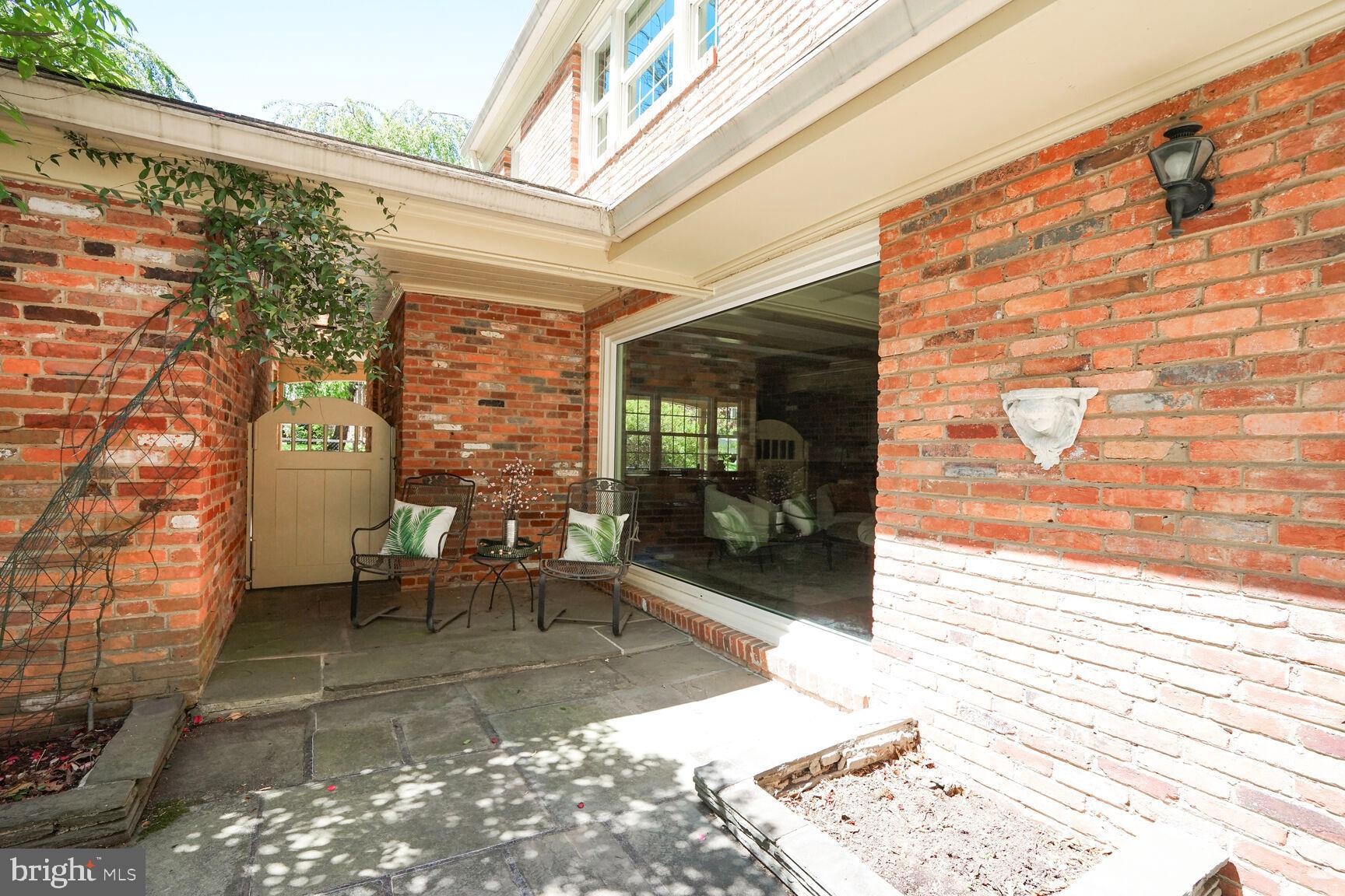 9111 Hamilton Drive Fairfax, VA 22031 - Photo 48 of 63 a view of a patio with a dining table and chairs with wooden floor and fence