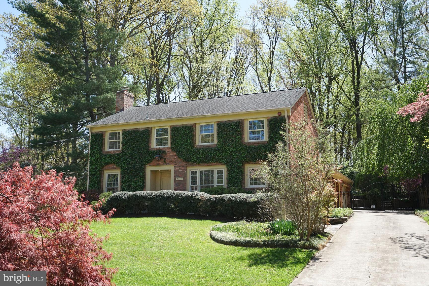 9111 Hamilton Drive Fairfax, VA 22031 - Photo 5 of 63 a front view of a house with a yard and garage