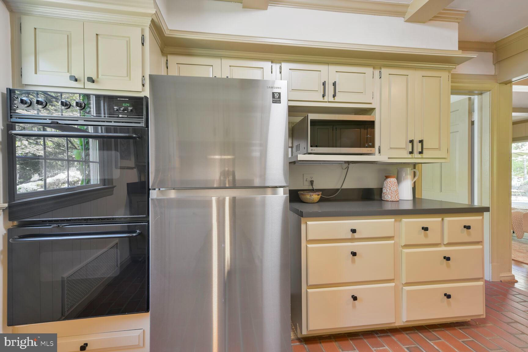 9111 Hamilton Drive Fairfax, VA 22031 - Photo 10 of 63 a kitchen with granite countertop white cabinets and stainless steel appliances