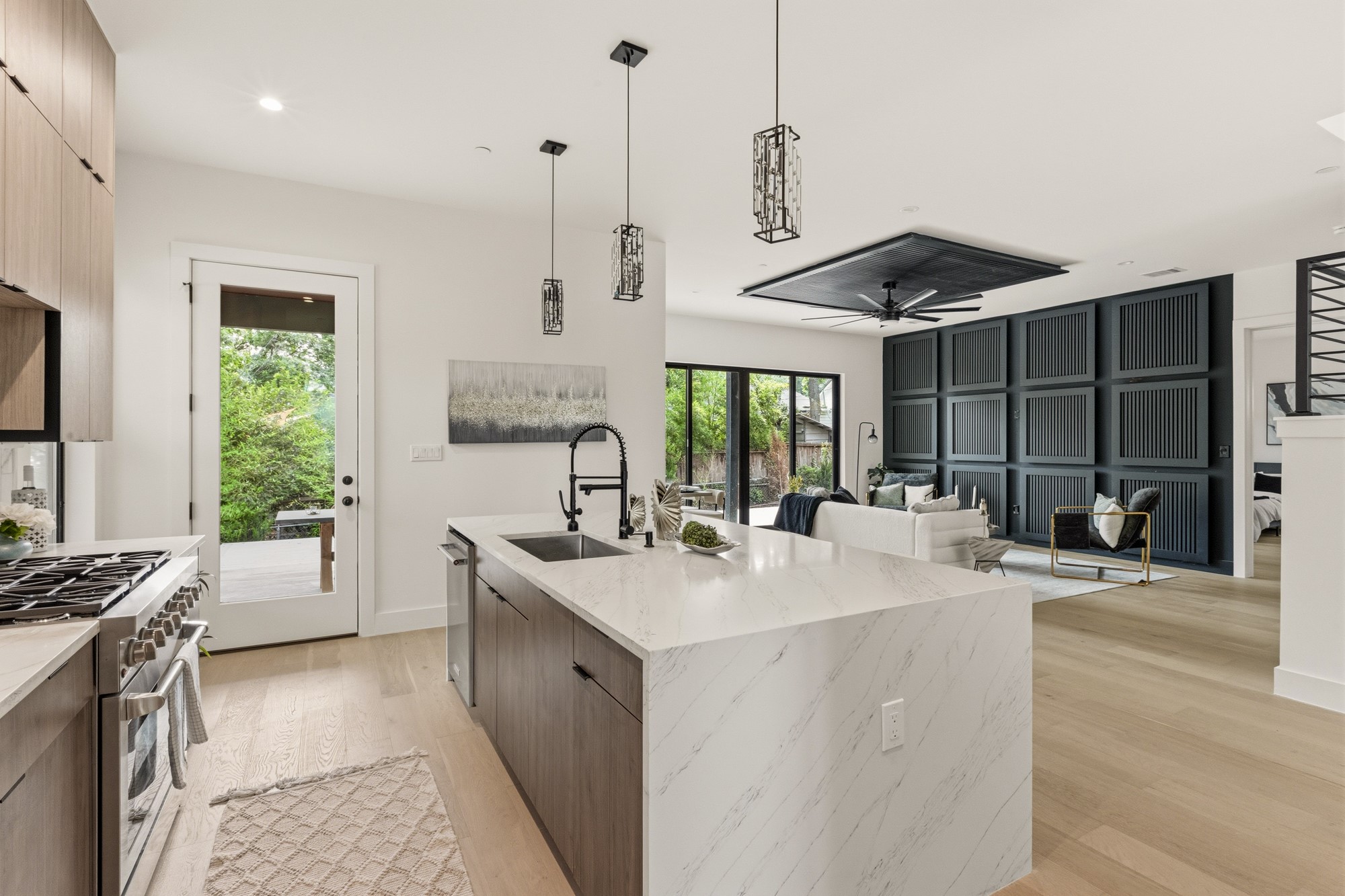 2300 Bluebonnet Lane Austin, TX 78704 - Photo 12 of 40 a kitchen with a stove a sink a counter top space and a window