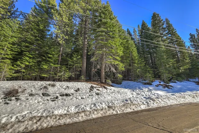 a view of a yard covered with snow in front of house