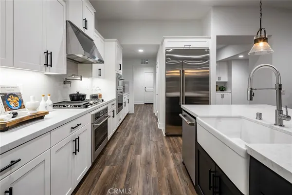 a kitchen with cabinets a sink and appliances