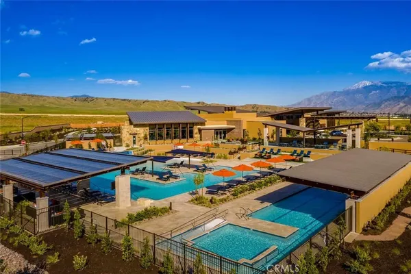 a view of a swimming pool with lawn chairs