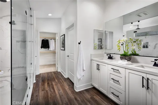 a bathroom with a sink a mirror and shower