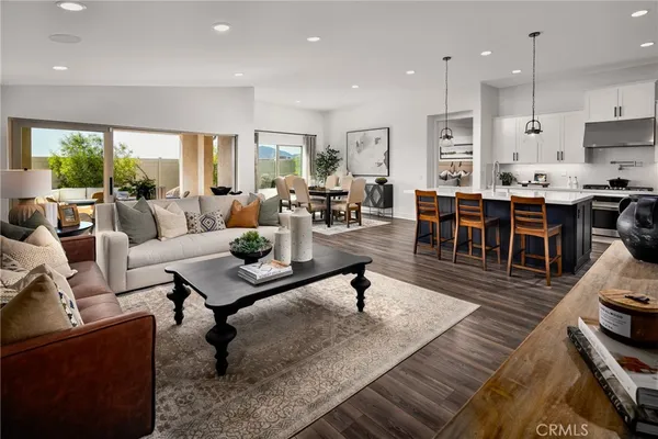 a living room with furniture kitchen view and a dining table