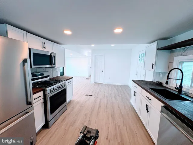 a kitchen with granite countertop a stove and a sink