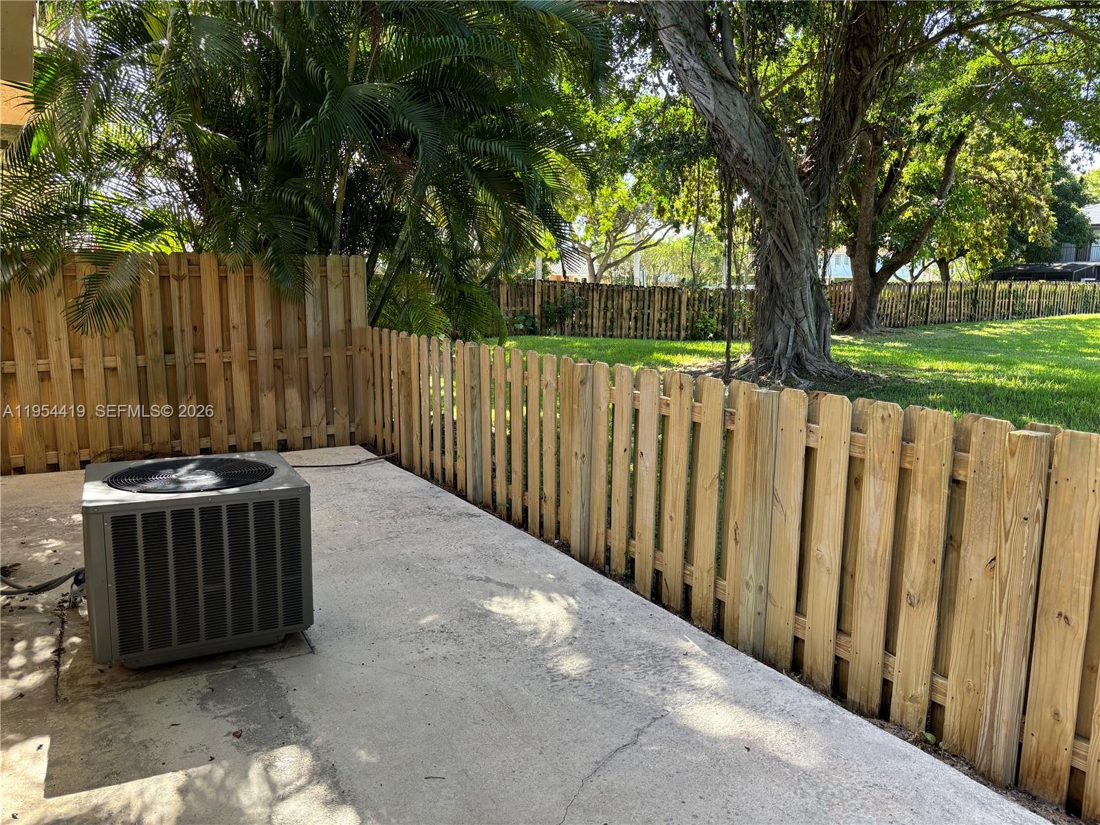 11132 Southwest 153rd Court Miami, FL 33196 - Photo 12 of 33 a view of backyard with wooden fence and trees