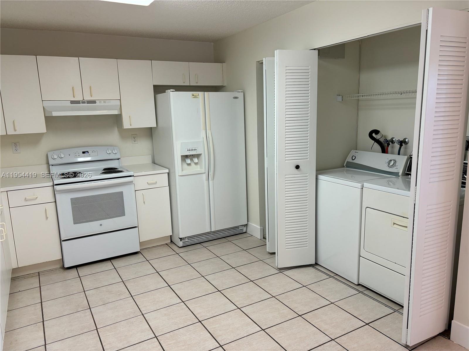 11132 Southwest 153rd Court Miami, FL 33196 - Photo 13 of 33 a kitchen with white cabinets appliances and sink