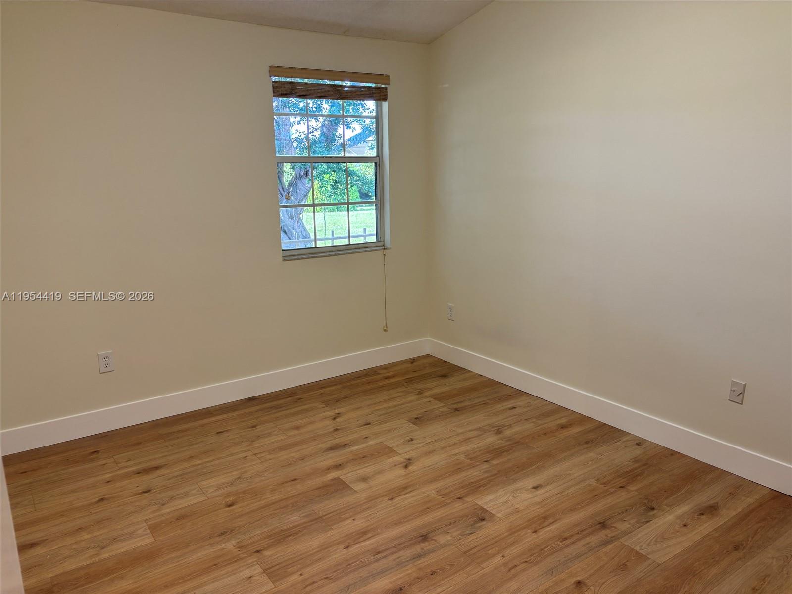 11132 Southwest 153rd Court Miami, FL 33196 - Photo 18 of 33 wooden floor in an empty room with a window