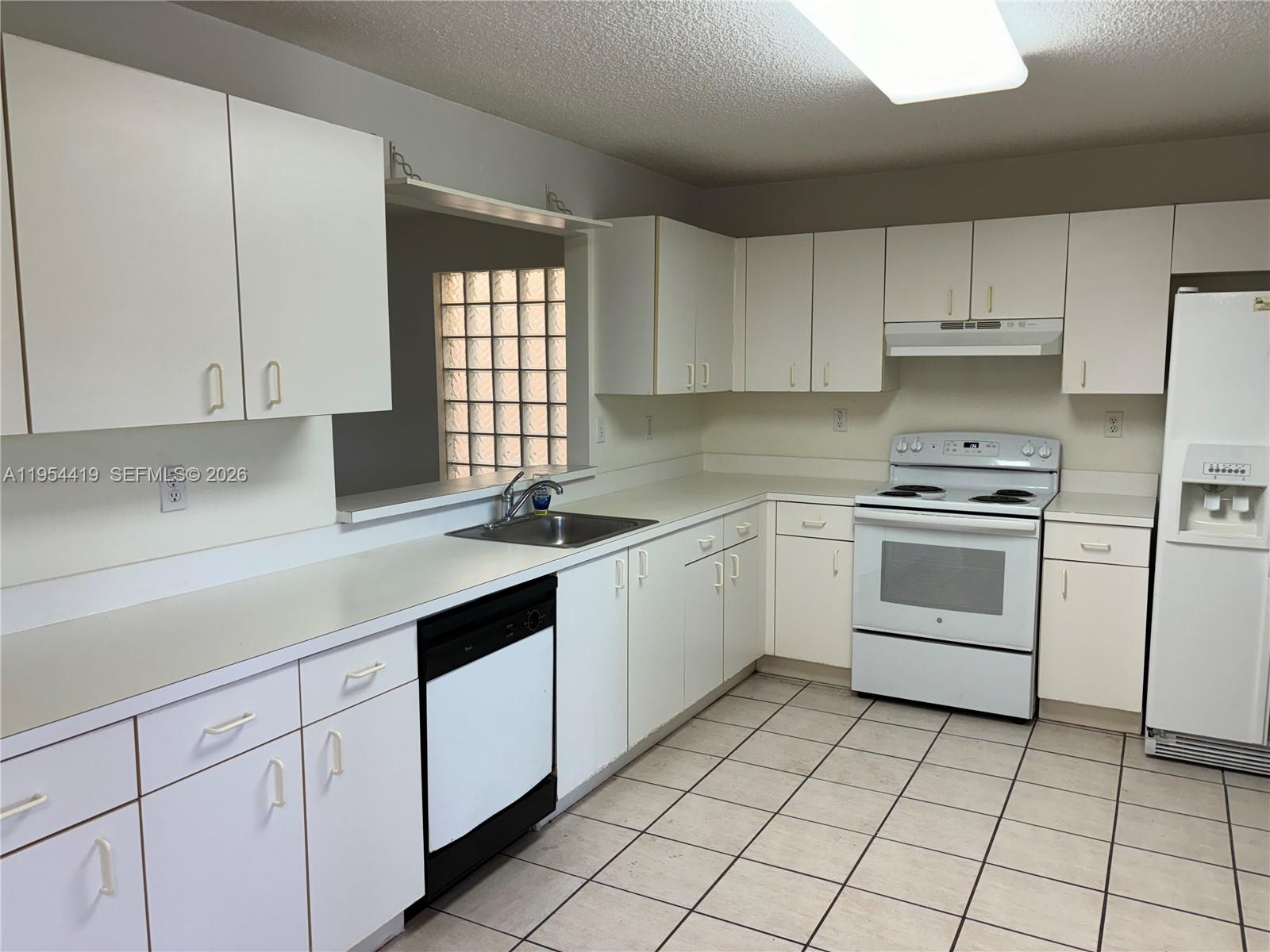 11132 Southwest 153rd Court Miami, FL 33196 - Photo 2 of 33 a kitchen with white cabinets appliances and a sink